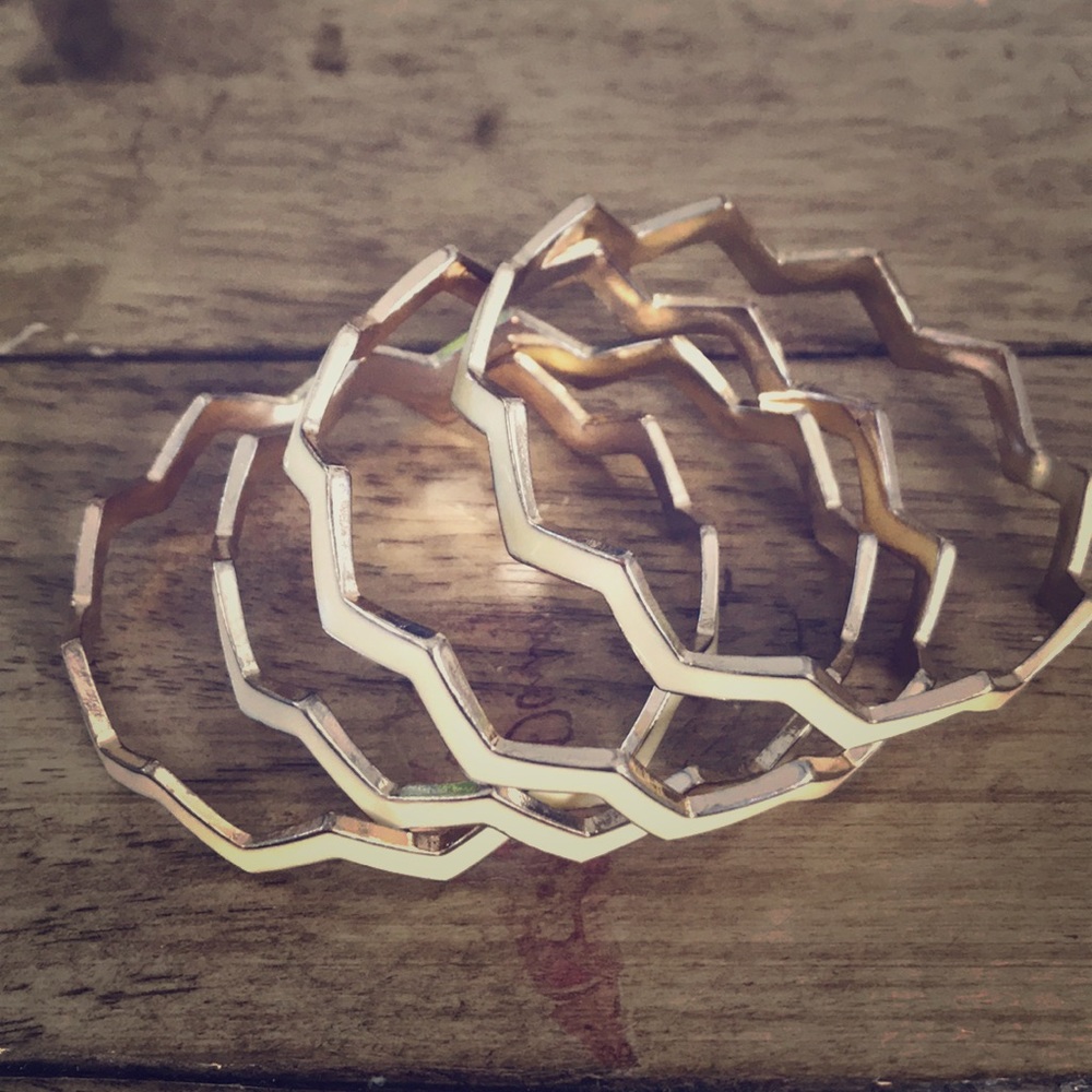 Set of 4 enamel off white chevron bracelets.